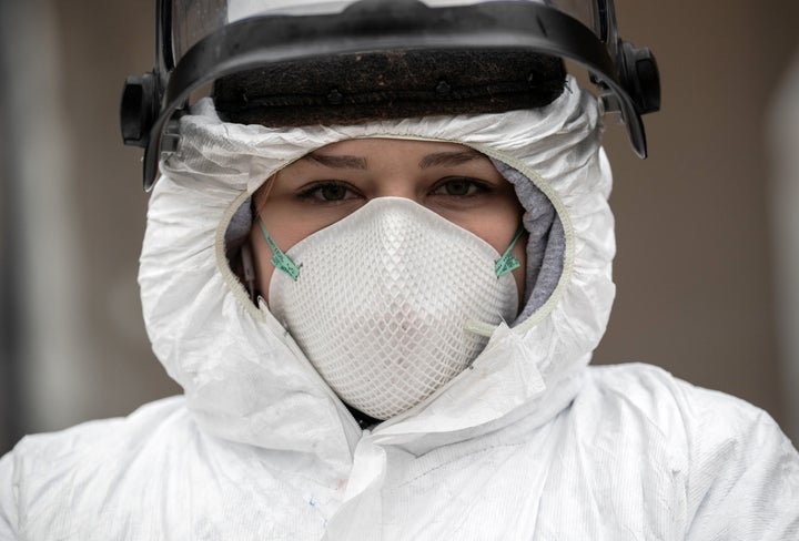 Nurse Hannah Sutherland, dressed in personal protective equipment, awaits new patients at a drive-thru coronavirus testing station at Cummings Park on March 23, 2020, in Stamford, Connecticut.