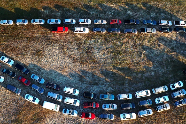 People line up in their cars to receive food assistance at the Share Your Christmas food distribution event on Dec. 9, 2020, in Groveland, Florida. Central Florida food banks struggled to serve those facing food insecurity during the holiday season amid the COVID-19 pandemic.