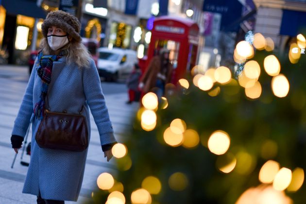 A citizen in a mask walks the streets of London, England.  The UK government's lockdown update has led to 18 million residents in London and the South East of England, excluding families living in a house at Christmas ...