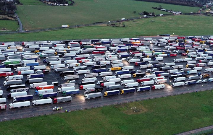 An aerial view shows lines of freight lorries and heavy goods vehicles parked on the tarmac at Manston Airport near Ramsgate
