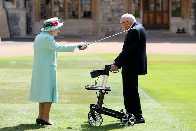 Britain's Queen Elizabeth awards Captain Tom Moore with the insignia of Knight Bachelor at Windsor Castle, in Windsor, Britain July 17, 2020. Chris Jackson/Pool via REUTERS     TPX IMAGES OF THE DAY