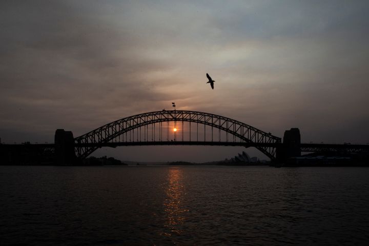 The sky above Sydney's harbour bridge was hazy as the sun rose on Jan. 5, 2020 and wildfires burned across eastern Australia. 