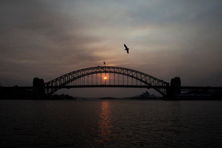 The sky above Sydney's harbour bridge was hazy as the sun rose on Jan. 5, 2020 and wildfires burned across eastern Australia.