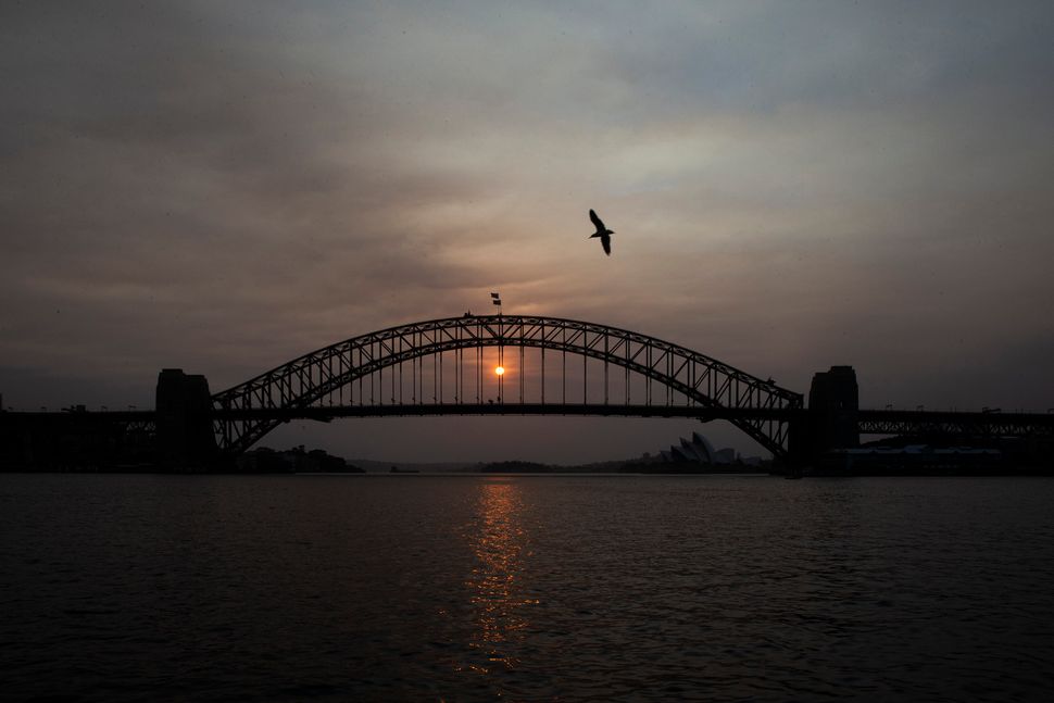 The sky above Sydney's harbour bridge was hazy as the sun rose on Jan. 5, 2020 and wildfires burned across eastern Australia. 