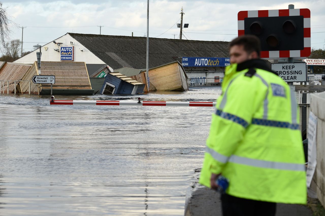 Flood water covers train track as at a railway crossing in Snaith, northern England on March 1, 2020 after Storm Jorge brought more rain and flooding to parts of the UK. 