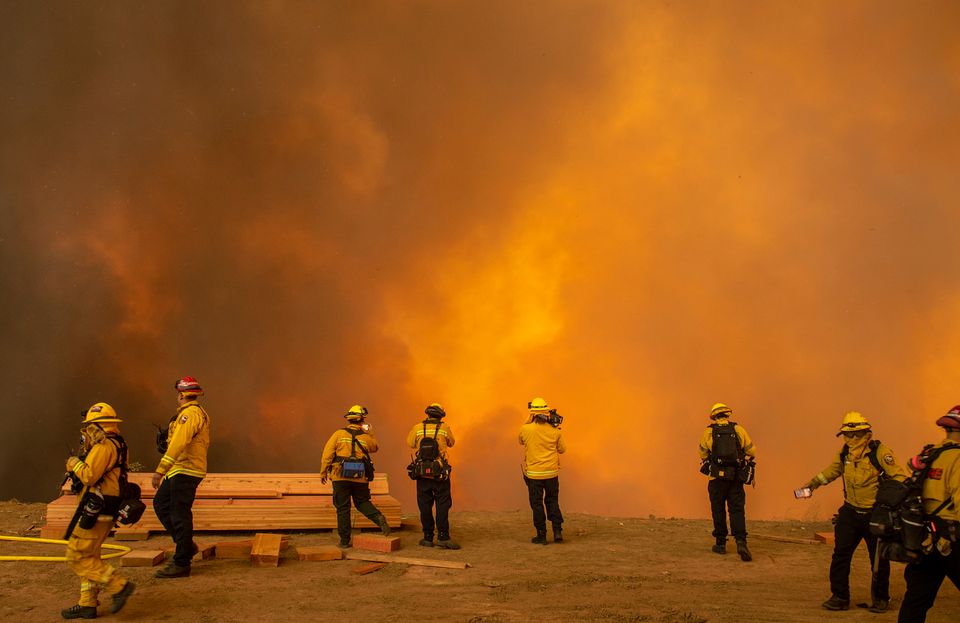 Firefighters with Cal Fire are enveloped in smoke as the Blue Ridge fire reaches homes on Hidden Glen Lane and Hidden Hills Road in Yorba Linda on Monday, October 26, 2020. 