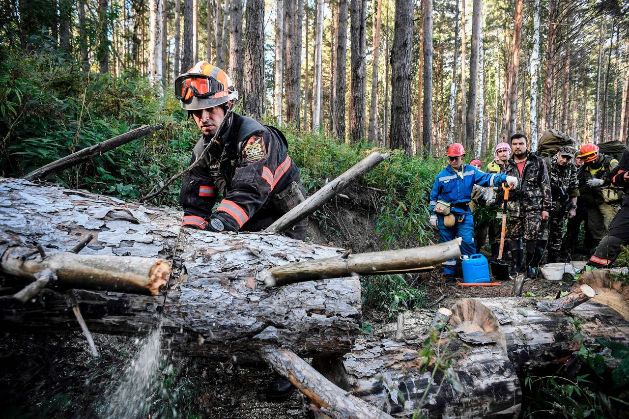 Greenpeace and local activists make their way through a Suzunsky forest next to the village of Shipunovo, 170 kms south from Siberian city of Novosibirsk on September 11, 2020, to extinguish a peat fire. 