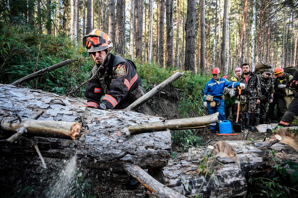 Greenpeace and local activists make their way through a Suzunsky forest next to the village of Shipunovo, 170 kms south from Siberian city of Novosibirsk on September 11, 2020, to extinguish a peat fire. 