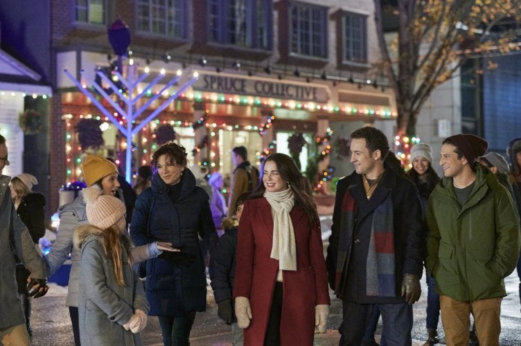 A scene from "Love, Lights, Hanukkah!" starring Mia Kirshner and Ben Savage.