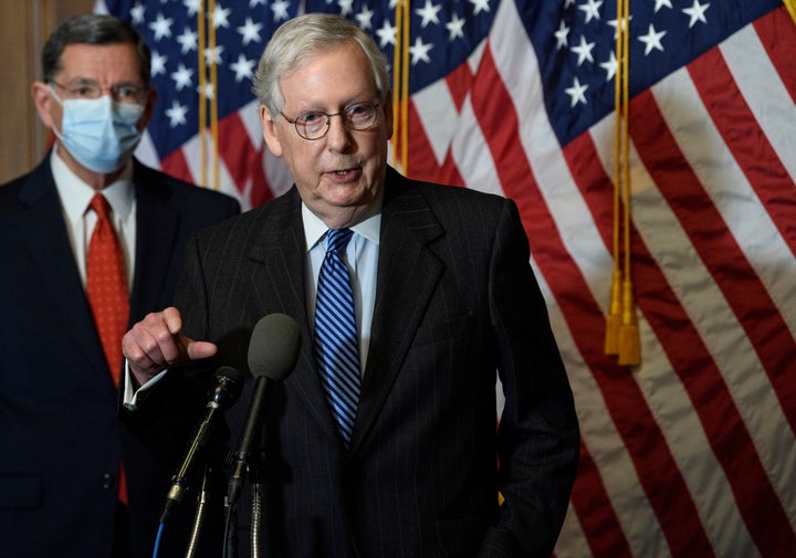 FILE - In this Tuesday, Dec. 15, 2020, file photo, Senate Majority Leader Mitch McConnell, of Kentucky, speaks during a news conference with other Senate Republicans on Capitol Hill in Washington, while Sen. John Barrasso, R-Wyoming, listens at left. “There will be another major rescue package for the American people," McConnell said in announcing an agreement for a relief bill, Sunday, Dec. 20, 2020, that would total almost $900 billion. “It is packed with targeted policies to help struggling Americans who have already waited too long.” (Nicholas Kamm/Pool Photo via AP, File)