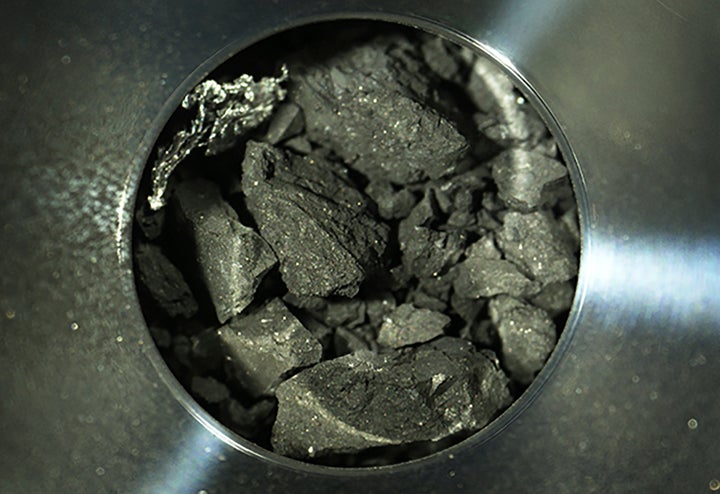 This optical microscope photo provided Thursday, Dec. 24, 2020, by the Japan Aerospace Exploration Agency (JAXA), shows soil