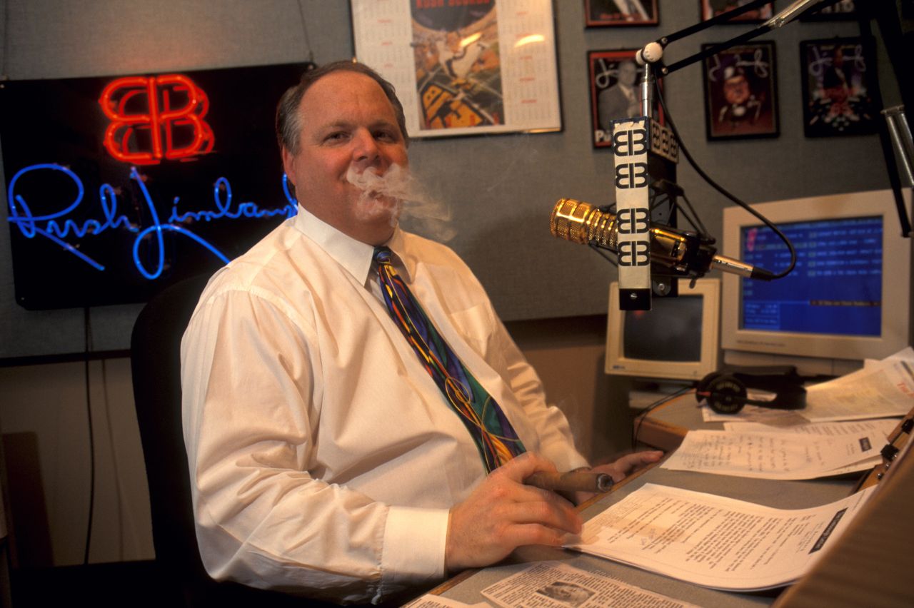 Rush Limbaugh smoking a cigar while taping his radio show.