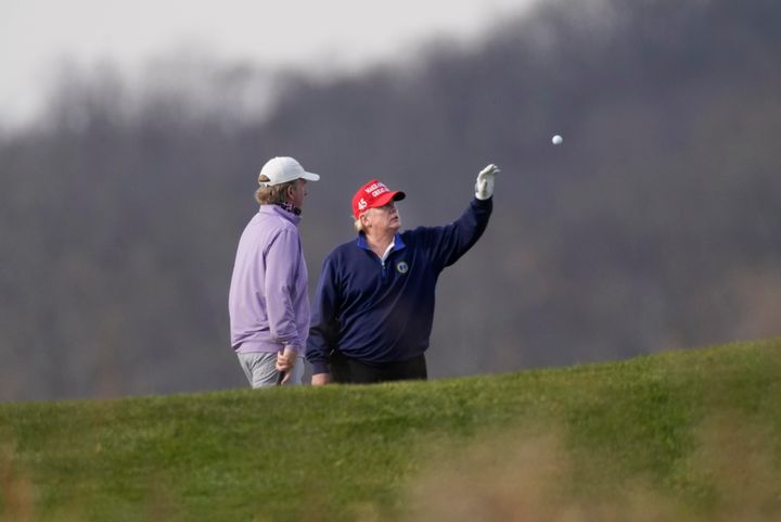 President Donald Trump is tossed a golf ball as he golfs at Trump National Golf Club in Sterling, Va., Sunday, Dec. 13, 2020. (AP Photo/Manuel Balce Ceneta)