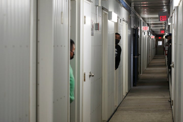 Migrant workers from Mexico wear masks and practice social distancing to help prevent the spread of the coronavirus disease during a mandatory 14-day quarantine after arriving at Mayfair Farms in Portage la Prairie, Man. on April 28, 2020. 