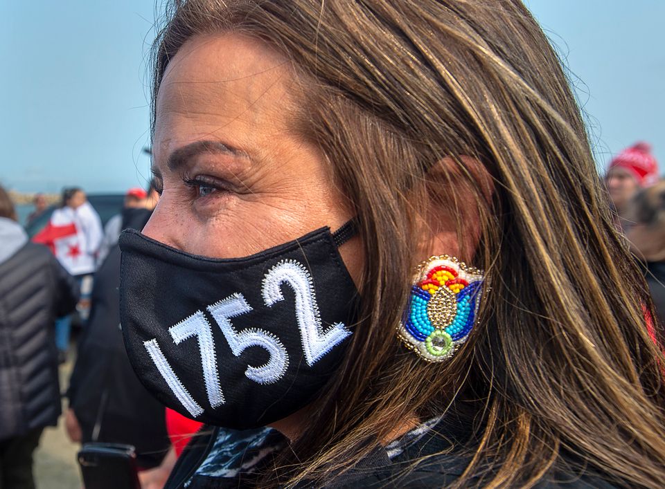 A woman wears a face mask honouring the Treaty of 1752 as members of the Sipekne'katik First Nation and...