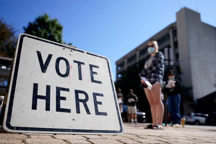 Voters stand in a line as they wait to vote early , Monday, Oct. 19, 2020, in Athens, Ga. With record turnout expected for this year's presidential election and fears about exposure to the coronavirus, election officials and advocacy groups have been encouraging people to vote early, either in person or by absentee ballot. (AP Photo/John Bazemore)
