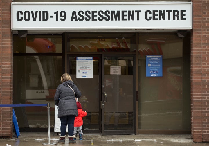 People line up at the COVID-19 assessment centre at Toronto Western Hospital on Dec. 25, 2020.