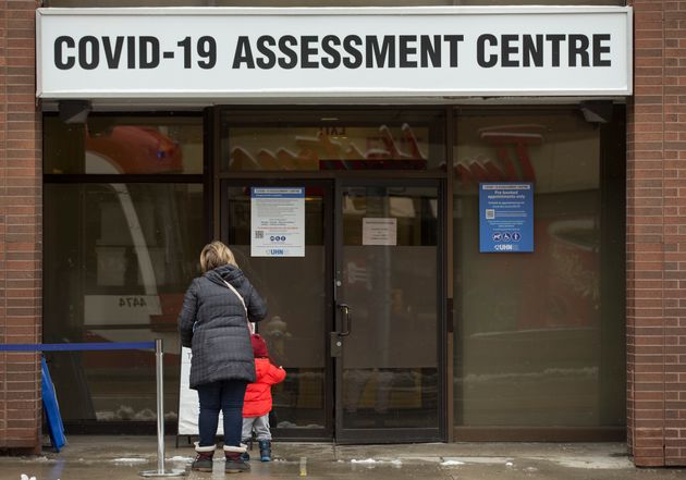 People line up at the COVID-19 assessment centre at Toronto Western Hospital on Dec. 25,