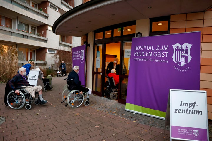 Residents of the 'Hospital zum Heiligen Geist' retirement home queue to enter the local vaccination center to be inoculated w