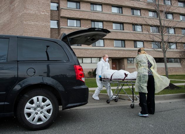 A person's body is wheeled from the Eatonville Care Centre in Toronto April 14,