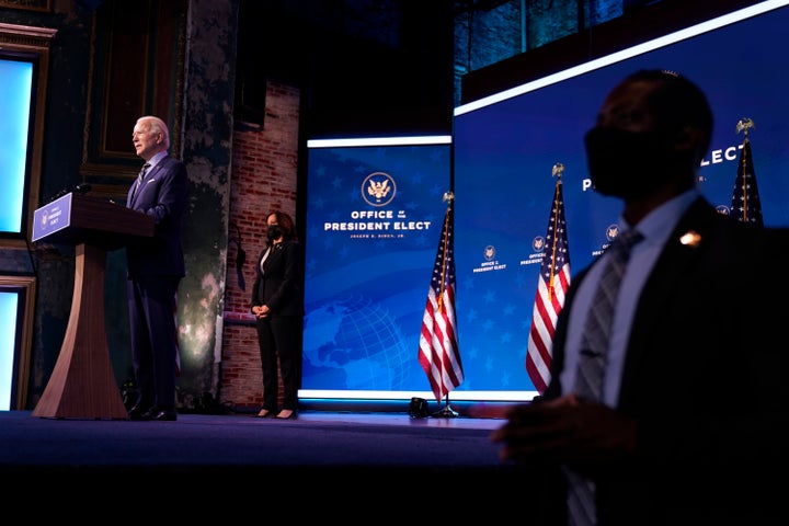 President-elect Joe Biden speaks Monday in Wilmington, Delaware. Vice President-elect Kamala Harris (center) listens.