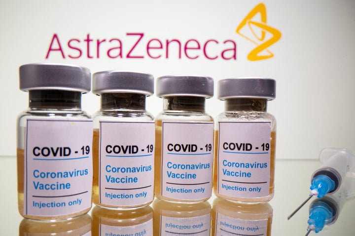 Vials with a sticker reading, "COVID-19 / Coronavirus vaccine / Injection only" and a medical syringe are seen in front of a displayed AstraZeneca logo in this illustration taken October 31, 2020. REUTERS/Dado Ruvic/Illustration