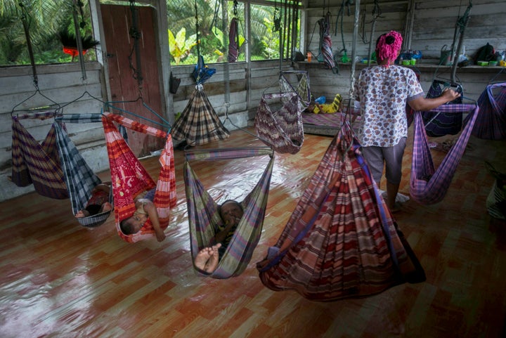 Babies and toddlers of female palm oil workers nap in a makeshift daycare center in Sumatra, Indonesia, as their parents work. Most mothers who work on palm oil plantations do not have access to childcare, forcing them to take their young children with them into the fields.