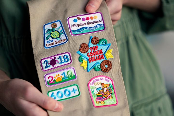 Olivia Chaffin displays merit badges that she has been awarded for selling Girl Scout Cookies in Jonesborough. She was a top 