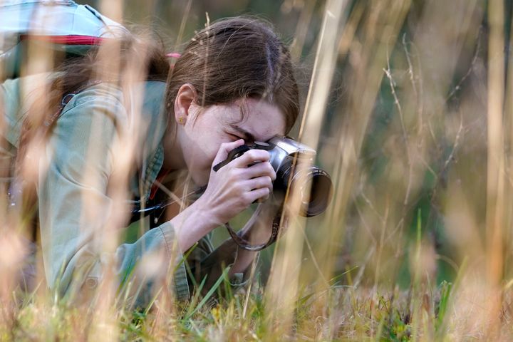 Olivia Chaffin takes photographs in a wooded area as she works on a Girl Scout photography merit badge in Jonesborough.