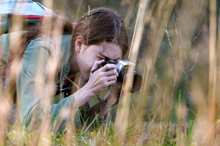 Olivia Chaffin takes photographs in a wooded area as she works on a Girl Scout photography merit badge in Jonesborough.