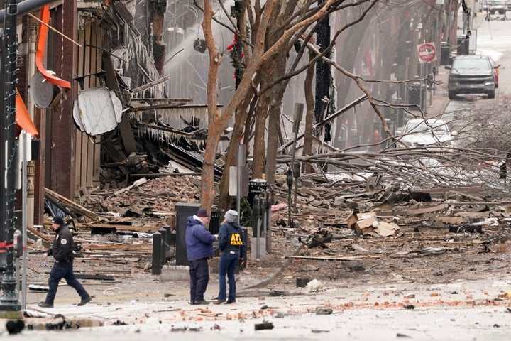 Emergency personnel work near the scene of the Christmas morning explosion in downtown Nashville that injured three people.