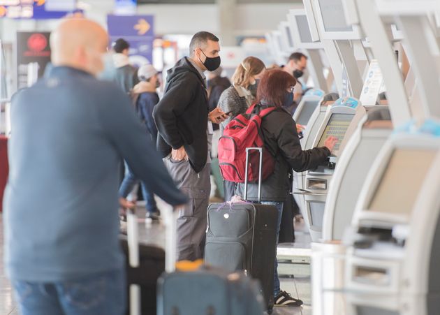 Passengers check-in using self-service desks at Montreal Trudeau International Airport in Montreal, Saturday,...