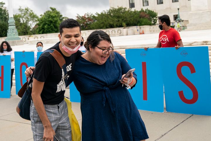 Greisa Martinez (R), who grew up as an undocumented immigrant in Dallas, Texas, reacts as she reads the Supreme Court's decision regarding the Trump administration's attempt to end DACA outside the U.S. Supreme Court on June 18, 2020, in Washington, D.C.