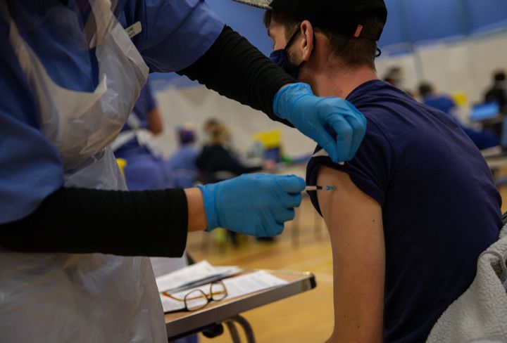 An NHS worker as he receives his first dose of the Pfizer/BioNTech vaccine on December 29.