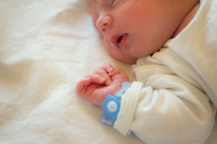 Newborn baby boy sleeping in his crib.