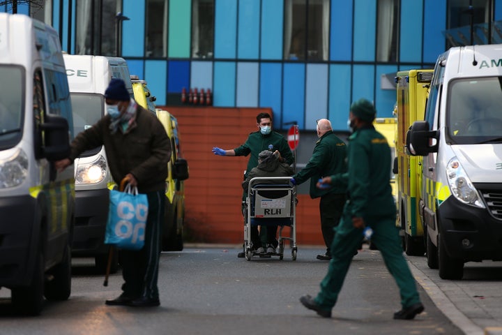 Paramedics wheel a patient into The Royal London Hospital.