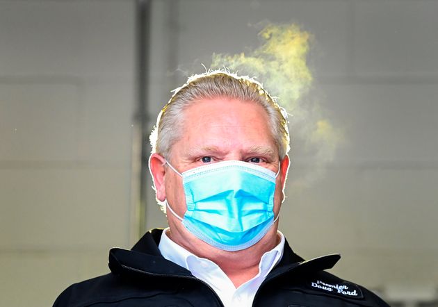 Steam rises, and is highlighted from a yellow light, off the head of Ontario Premier Doug Ford as he...