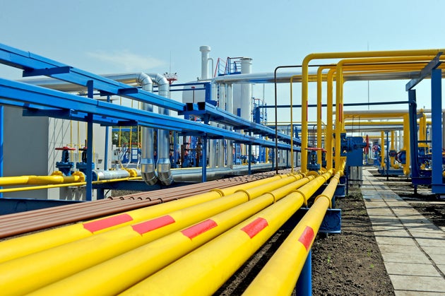 Yellow gas pipes in natural gas treatment plant in bright sunny summer