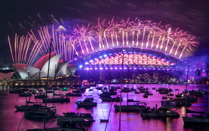 Fireworks explode over the Sydney Opera House and Harbour Bridge as New Year celebrations begin in Sydney, Australia, Thursday, Dec. 31, 2020. One million people would usually crowd the Sydney Harbor to watch the annual fireworks that center on the Sydney Harbour Bridge. But this year authorities advised revelers to watch the fireworks on television as the two most populous states, New South Wales and Victoria battle to curb new COVID-19 outbreaks. (AP Photo/Mark Baker)