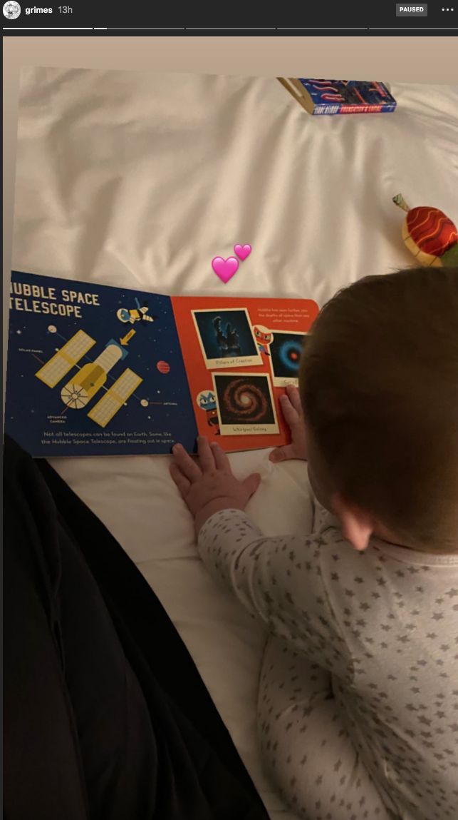 Little X enjoying a book about the Hubble Space Telescope.