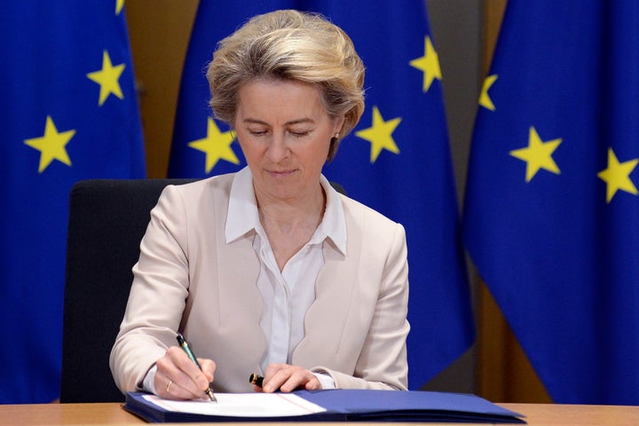 European Commission President Ursula von der Leyen signs the EU-UK Trade and Cooperation Agreement at the European Council headquarters in Brussels, Wednesday, Dec. 30, 2020. (Johanna Geron, Pool Photo via AP)