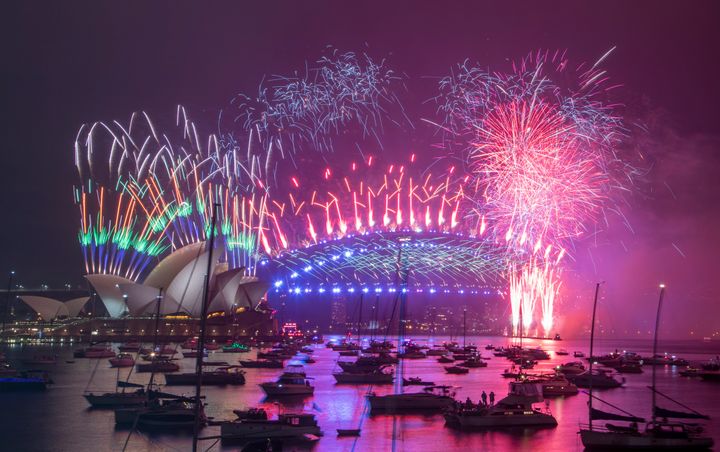 Fireworks explode over the Sydney Opera House and Harbour Bridge as New Year celebrations begin in Sydney, Australia, Friday,