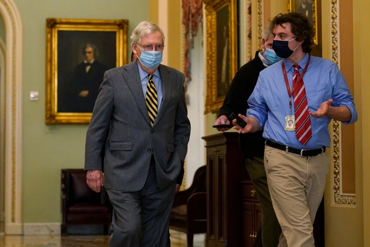 Senate Majority Leader Mitch McConnell of Ky., is followed by a reporter as he arrives on Capitol Hill in Washington, Wednesday, Dec. 30, 2020. (AP Photo/Susan Walsh)