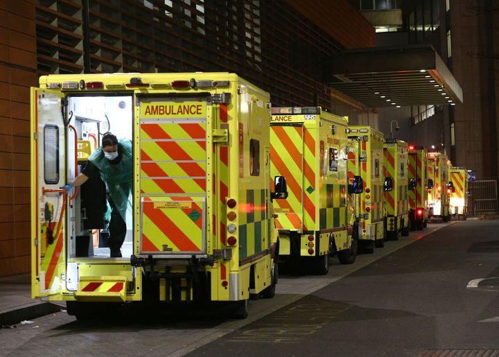A row of ambulances are parked outside the Royal London Hospital in London on Tuesday, Dec. 29, 2020. British officials are considering tougher coronavirus restrictions as the number of hospitalized COVID-19 patients surpasses the first peak of the outbreak in the spring. (Yui Mok/PA via AP)