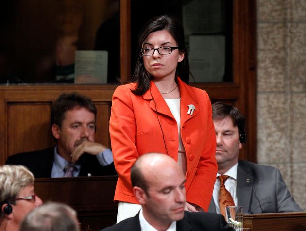 New Democratic Party Member of Parliament Niki Ashton stands to vote in the House of Commons on Parliament...