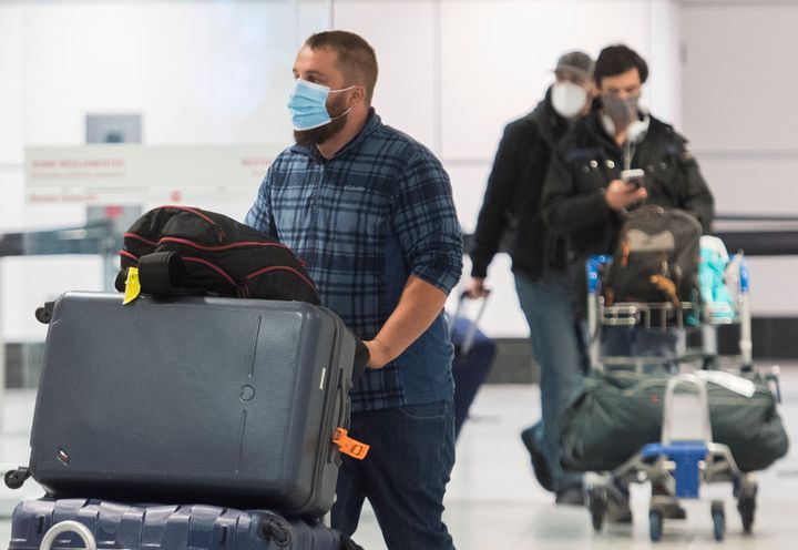 Passengers are shown in the international arrivals hall at Trudeau Airport in Montreal on Dec. 29, 2020.