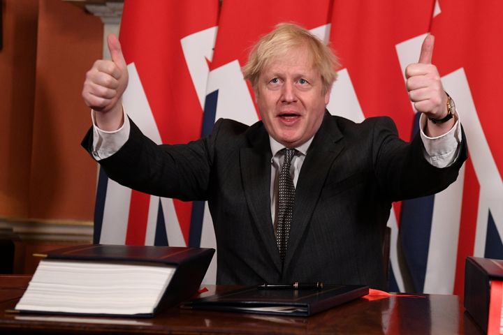 Johnson gives a thumbs up after signing the Brexit trade deal with the EU at number 10 Downing Street on December 30.