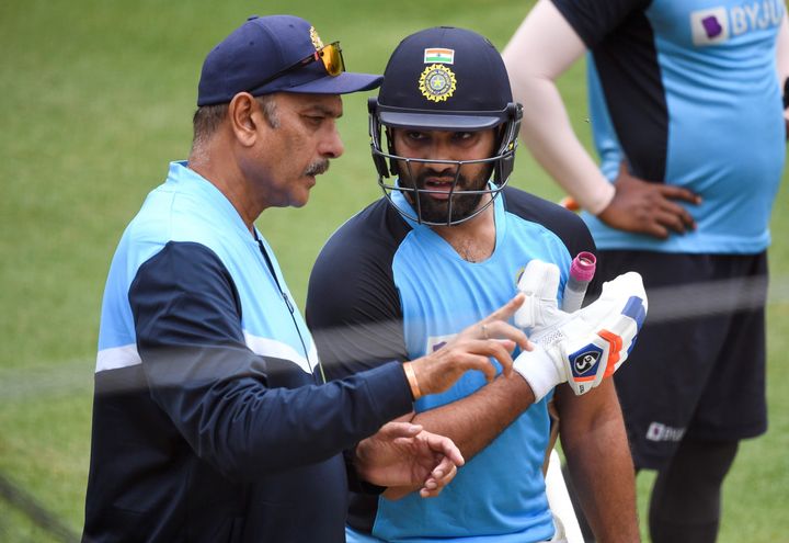 India's Rohit Sharma (R) chats with team coach Ravi Shastri (L) during a training session at the MCG in Melbourne on January 2, 2021, ahead of the third cricket Test match in Sydney on January 7. 