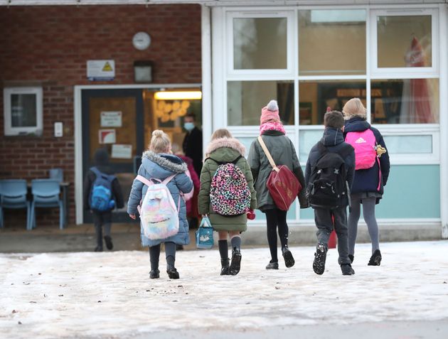 Pupils arrive at Manor Park School and Nursery in Knutsford, England, as schools across England return after the Christmas break, Monday, Jan. 4, 2021. 