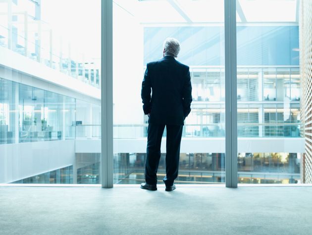 A top executive looks outside of a window in this stock photo. A new report says the average pay of a...